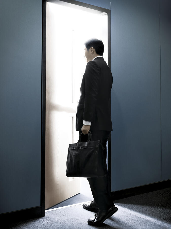 Asian Businessman Walking into an Office Photograph by Stevecoleimages