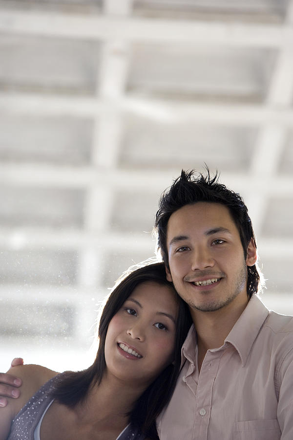 Asian couple hugging Photograph by Klaus Tiedge