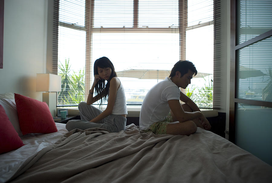 Asian Couple Waking Up Photograph by Fuse