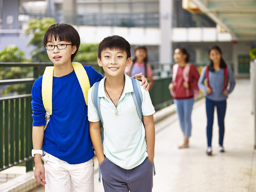 Asian Elementary Schoolboys Walking In School Photograph by Imtmphoto