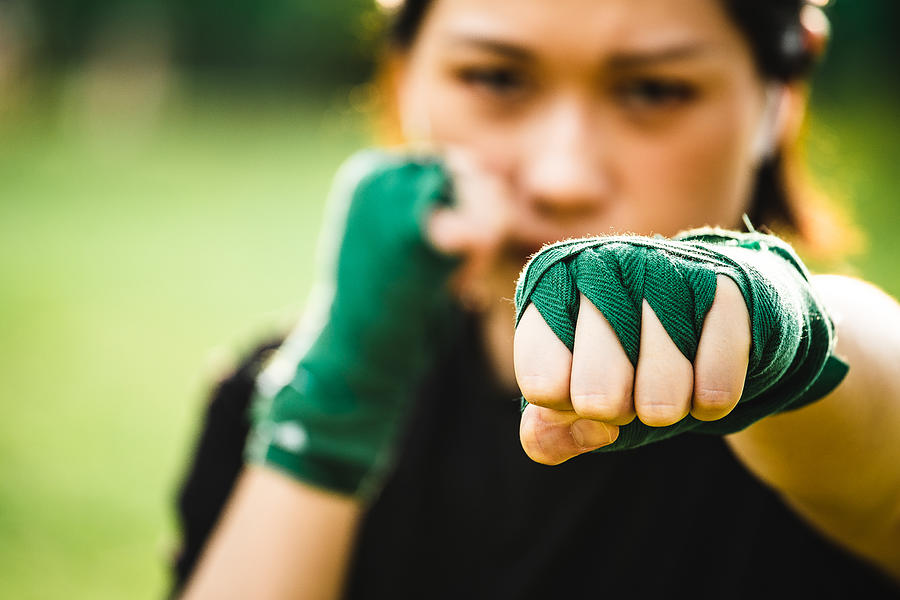 Asian female practicing mixed martial art outdoor Photograph by Kilito Chan