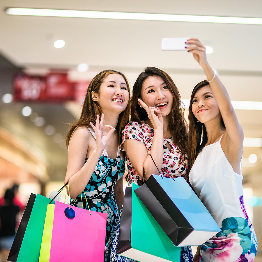 Asian friends shopping in the mall and take a selfie Photograph by Franckreporter