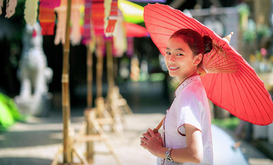 Asian girl in northern traditional costume and red umbrella stan Photograph by Anek Suwannaphoom