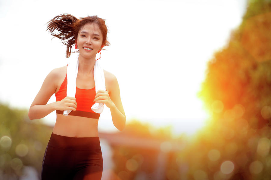 Asian girl running in the Park and doing exercises Jogging #3 by Anek  Suwannaphoom