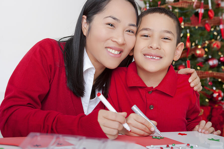 Asian mother and son making christmas cards Photograph by ChristopherBernard