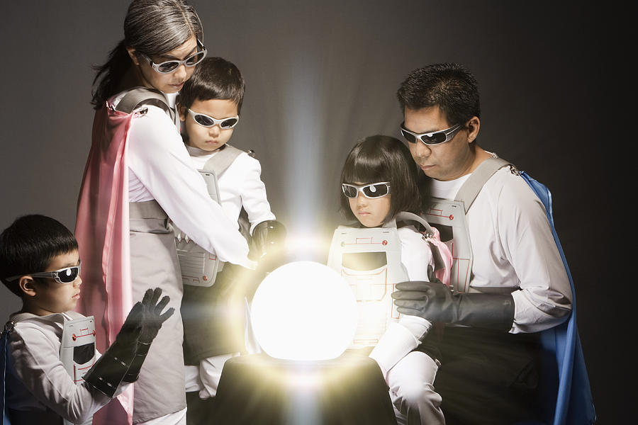 Asian superhero family watching glowing orb Photograph by Hill Street Studios