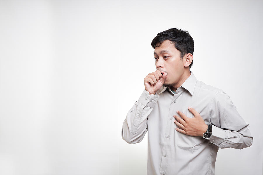 Asian young men is Coughing as a Covid symptoms Photograph by Fajrul Islam