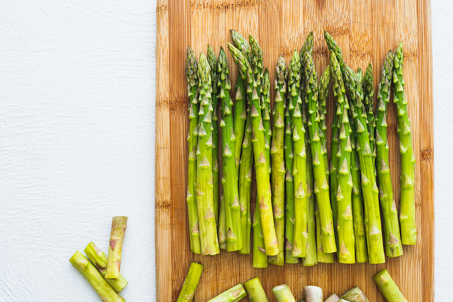 Asparagus on a Wooden Chopping Board, Top View, Close Up on White Background. Cooking, Vegetarian, Healthy Eating Photograph by Nature, food, landscape, travel
