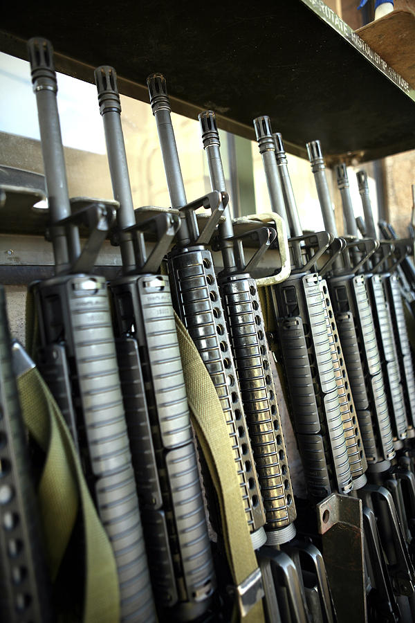 Assault rifles stand ready on the weapons rack. Photograph by Stocktrek Images