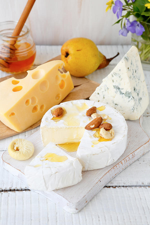 Assorted cheese on a cutting board Photograph by Olha_Afanasieva