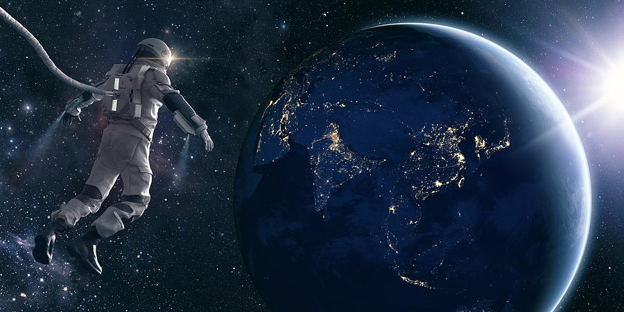 Astronaut On Space Walk Looks At Lights of Planet Earth Photograph by Peepo
