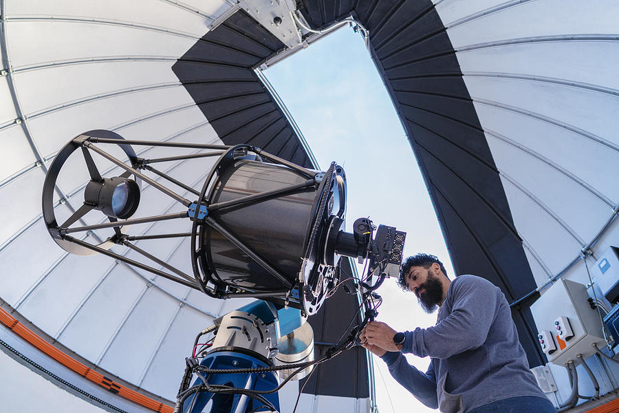 Astronomer in photo telescope dome Photograph by Mediterranean