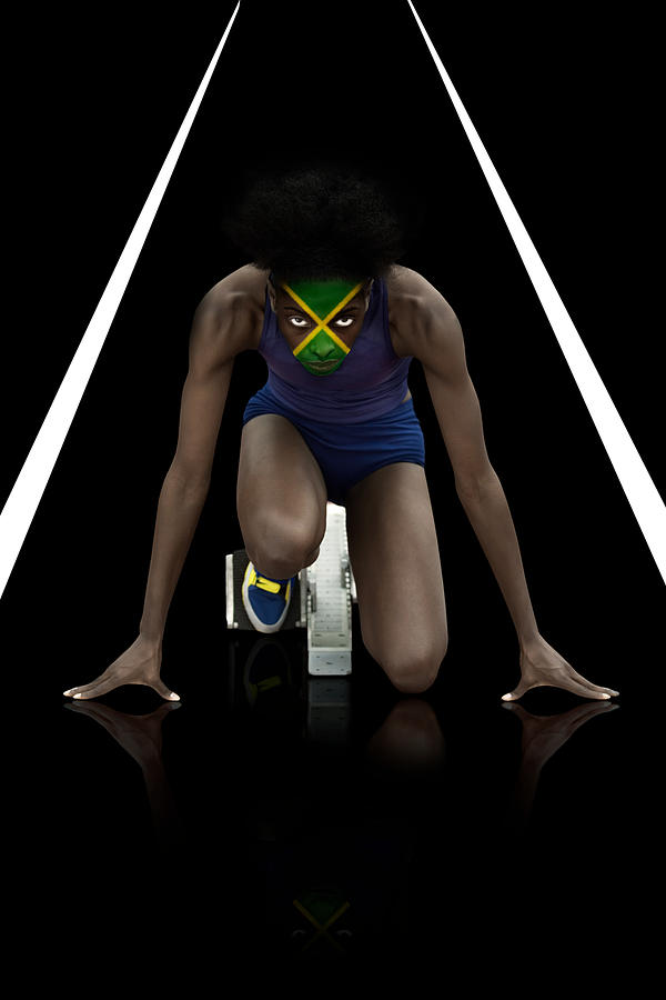 Athlete with jamaican flag face paint Photograph by Image Source