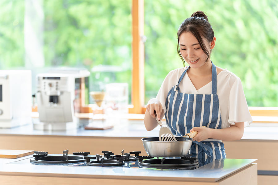 Attractive Japanese Woman Cooking In The Kitchen Photograph by Itakayuki