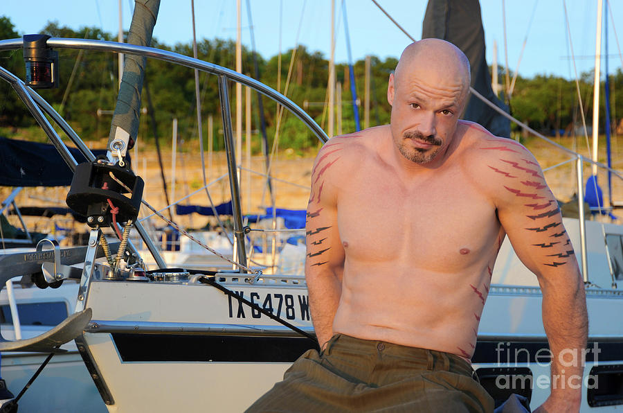 Attractive man with bald head and goatee poses by sailboat Photograph by Gunther Allen