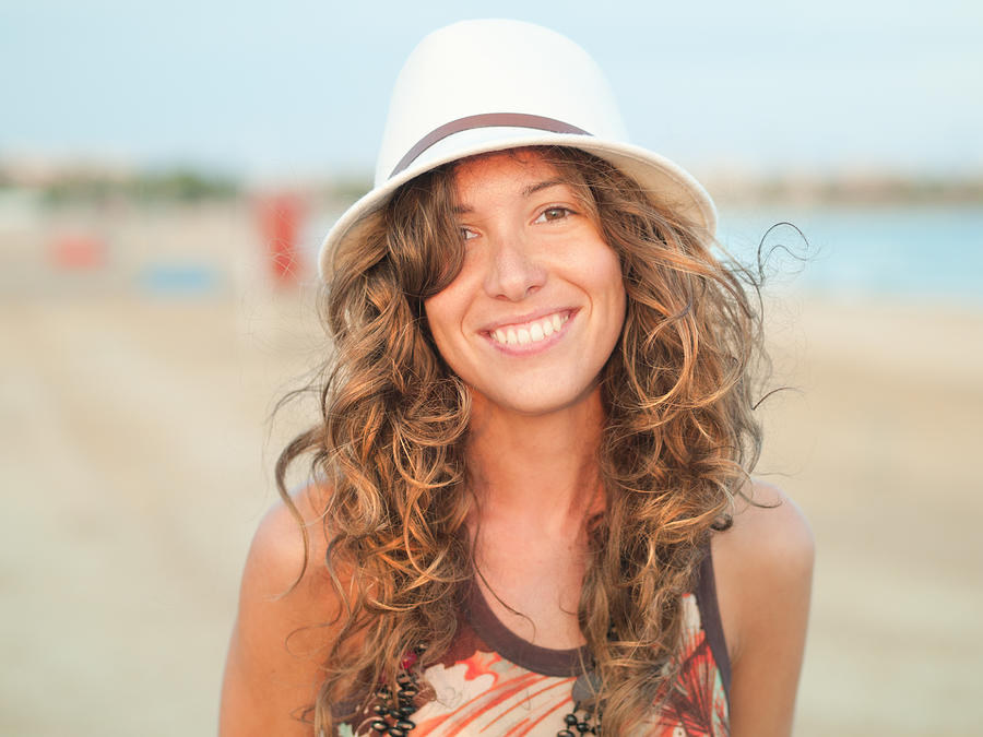 Attractive woman smiling on the beach Photograph by Rafael Elias