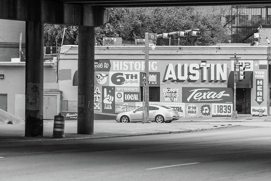 Austin Black and White on building with highway underpass  Photograph by John McGraw
