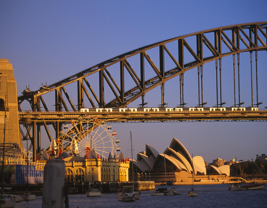 Australia, New South Wales, Sydney, Opera House and Sydney Harbour Bridge at sunset Photograph by Grant Faint
