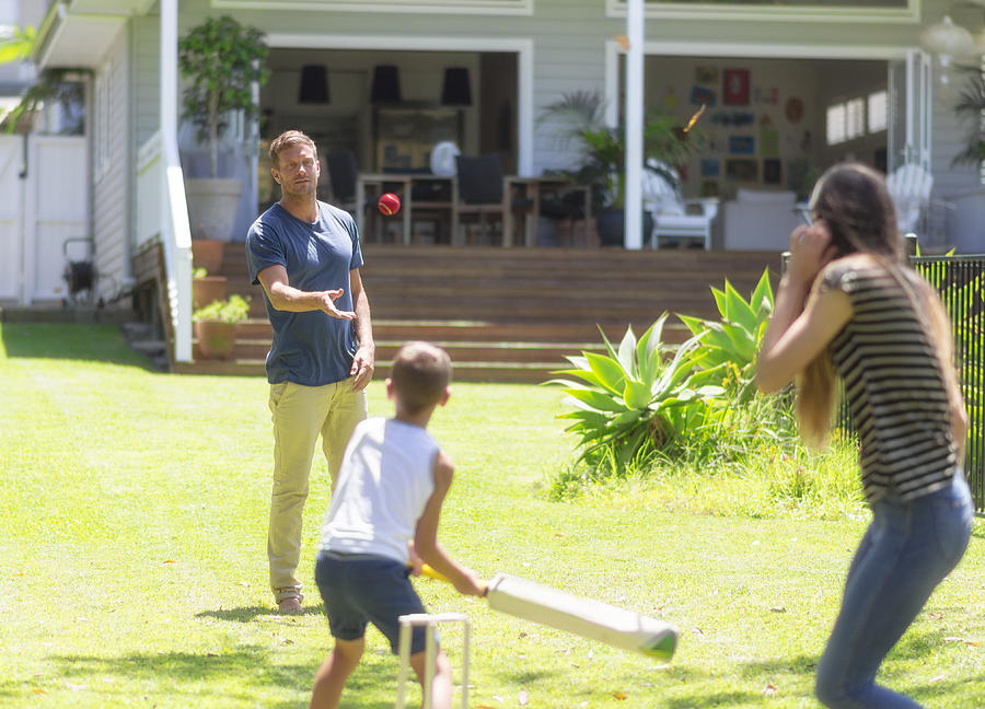 Australian family playing cricket Photograph by Funky-data