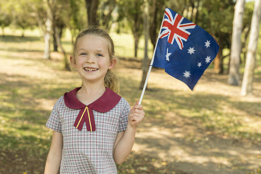 Australian Flag Waving by Primary School Girl Student for Australia Day Photograph by Davidf