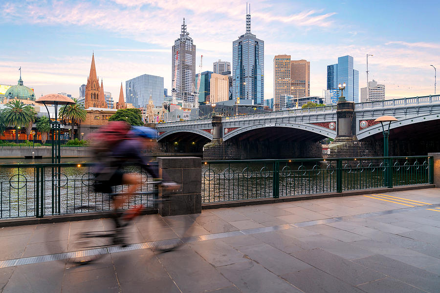 Australian people cycling  for exercise near Yarra River with view of the Melbourne City Financial District with skyscrapers in morning at Melbourne, Victoria, Australia. Photograph by Prasit photo