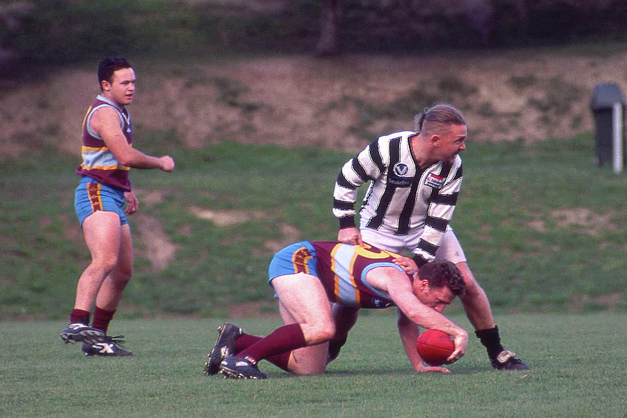 Australian Rules Football - Hes Down Photograph by Jerry Griffin