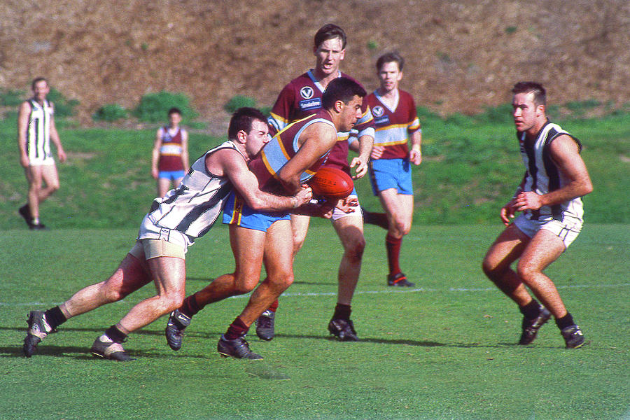 Australian Rules Football - Tackled from Behind Photograph by Jerry Griffin