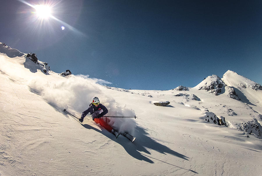 Austria, Skier doing turn in fresh powder snow Photograph by Coberschneider