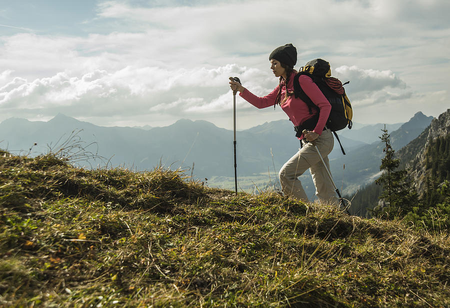 Austria, Tyrol, Tannheimer Tal, young woman hiking on alpine meadow Photograph by Westend61