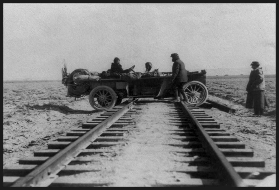 Automobile straddling railroad tracks, 1908 Photograph by Vincent Monozlay