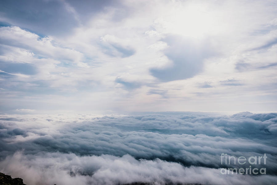 Awesome view on top of the clouds on a cloudy morning. Photograph by Joaquin Corbalan