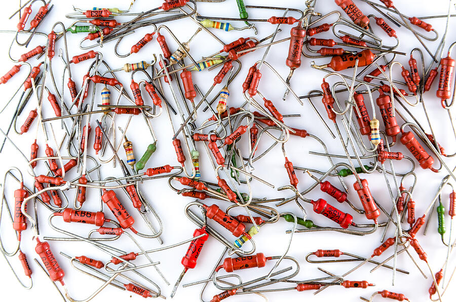 Axial resistors in bulk on white background isolated. Photograph by Oleg Shvydiuk