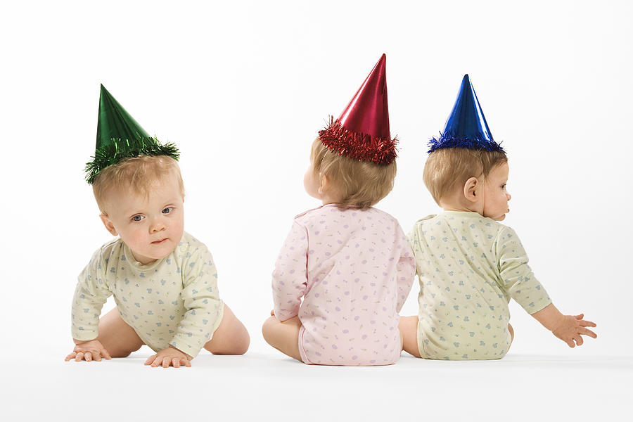 Babies in party hats Photograph by Thinkstock