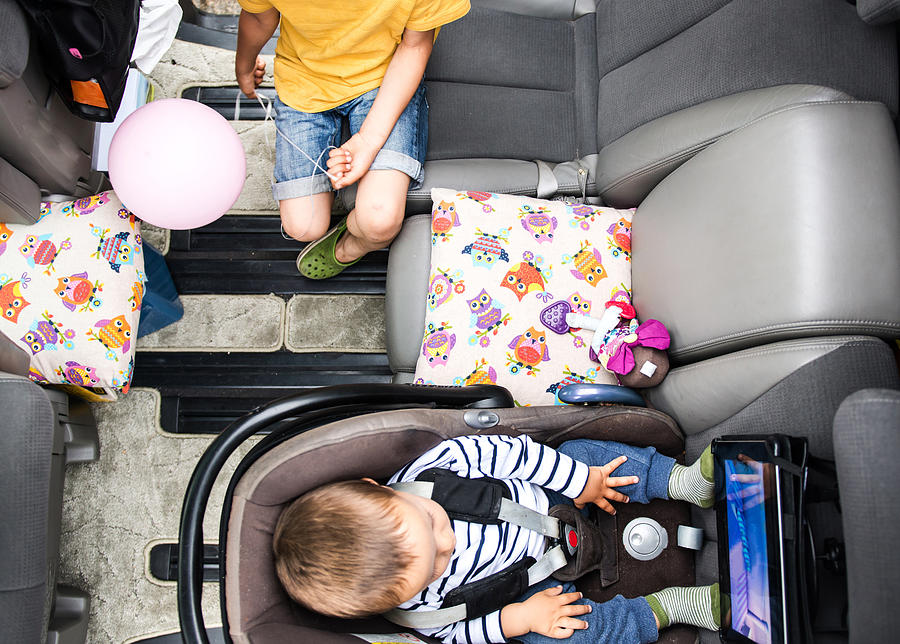 Baby and big brother watching movie in car Photograph by Bonfanti Diego