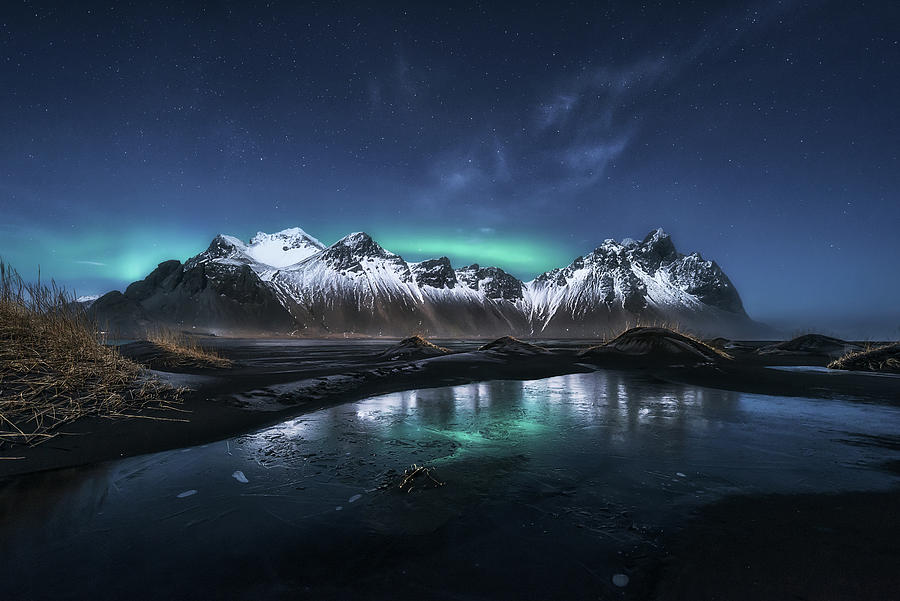 Baby-Aurora over Stokksnes Photograph by Manuel Martin