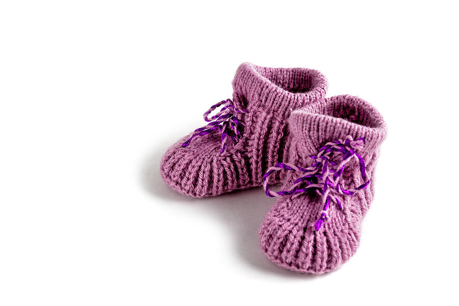 Baby booties on white background. Knitted. Photograph by Irina Vodneva