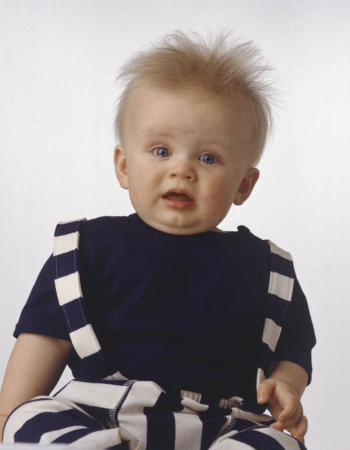 Baby boy (15-18 months) sitting, posing in studio, (Portrait) Photograph by Kevin Peterson