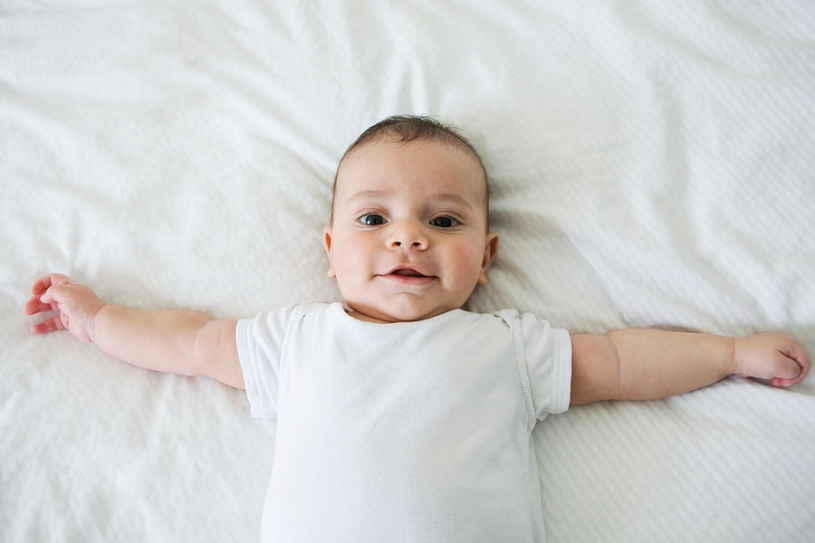 Baby boy lying on back Photograph by Image Source
