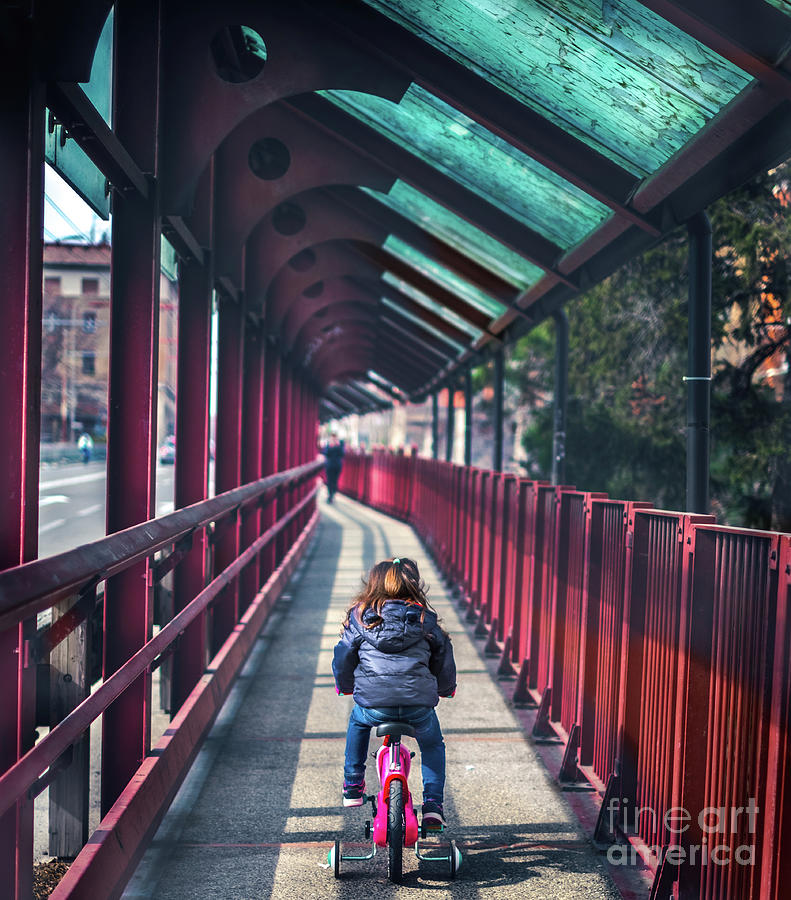 Baby Cycling Seen From Back Background Of Red Bridge Deserted With No People Photograph by Luca Lorenzelli