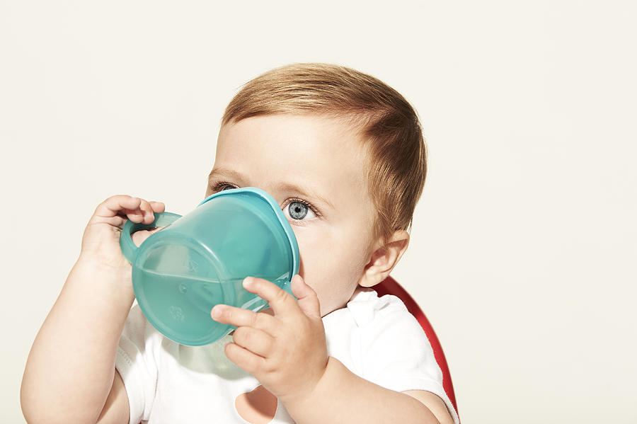Baby drinking water Photograph by Plume Creative