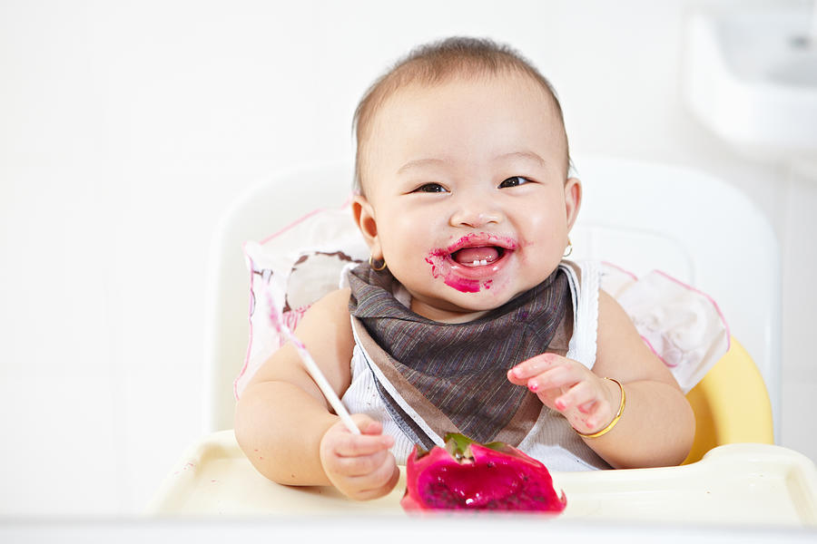 Baby eating dragon fruit Photograph by AtnoYdur