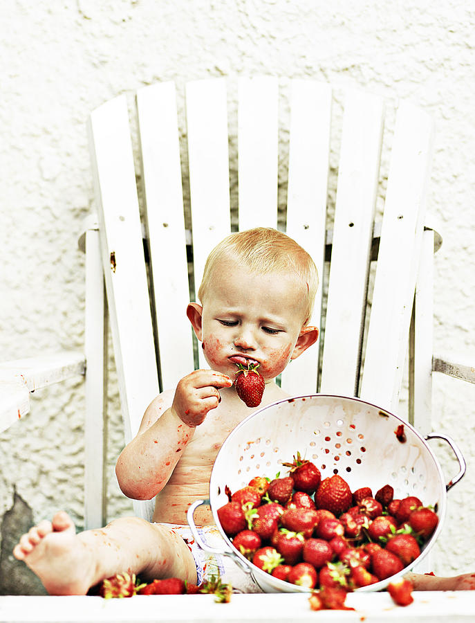 Baby eating strawberries Photograph by David Trood