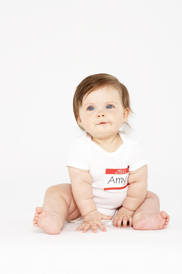 Baby girl (6-9 months) sitting on white background Photograph by Siri Stafford