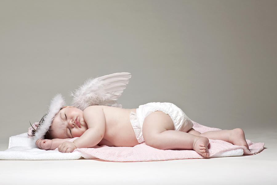 Baby girl angel sleeping on blanket Photograph by Tripod