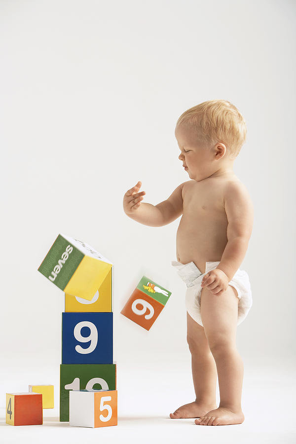Baby Knocking Over Blocks Photograph by Moodboard