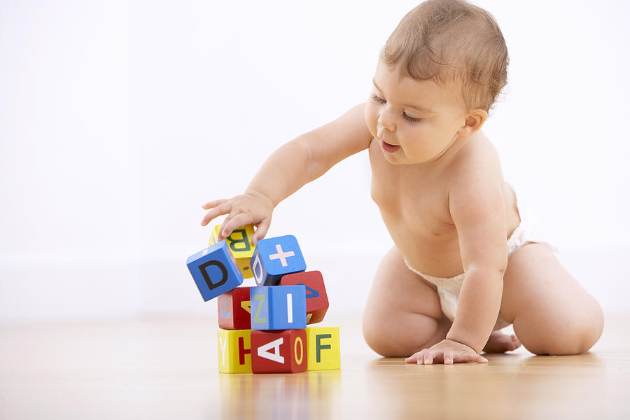 Baby playing with alphabet blocks Photograph by Adam Gault