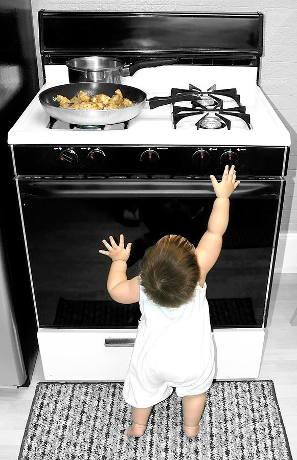 Baby Reaching for Stove Photograph by Renphoto