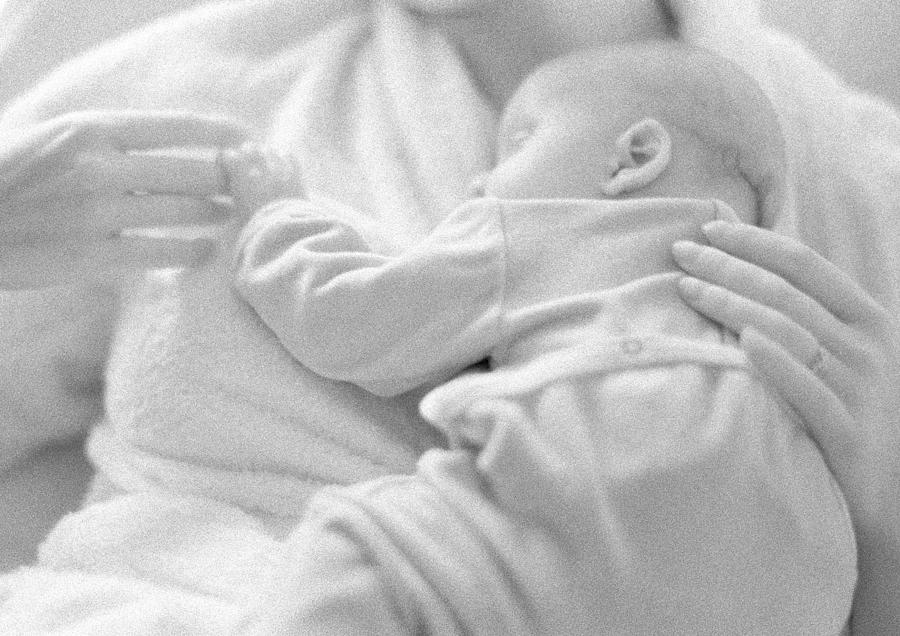 Baby sleeping on mothers chest, b&w Photograph by John Dowland