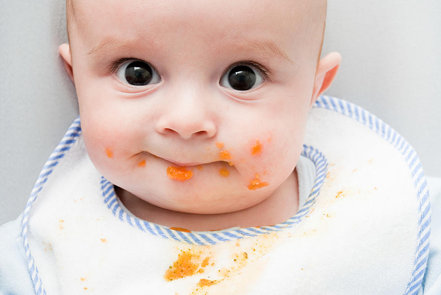Baby with food on his face Photograph by Image Source