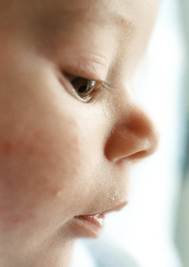Babys face, side view, looking down, close-up Photograph by Michele Constantini